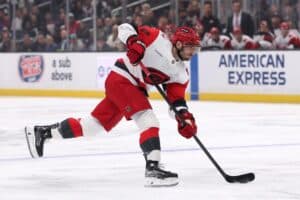 Shayne Gostisbehere #4 of the Carolina Hurricanes shoots the puck against the Los Angeles Kings.