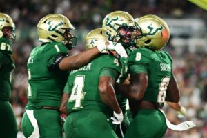 The South Florida Bulls, our top Thursday night college football bet, celebrate against the Florida Atlantic Owls.