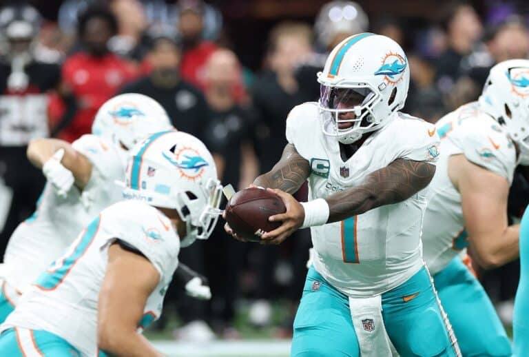 Tua Tagovailoa #1 of the Miami Dolphins steps back to hand off against the Atlanta Falcons.