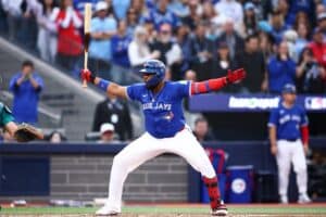 Vladimir Guerrero Jr. #27 of the Toronto Blue Jays reacts to a pitch against the Seattle Mariners.