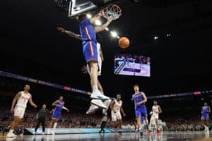 Alex Condon #21 of the Florida Gators dunks the ball against the Houston Cougars defense. College basketball picks today