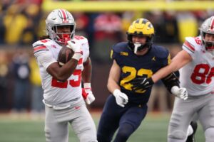 Ohio State v Michigan - Oddstrader The cover for this Saturday night football bets article shows Bo Jackson #25 of the Ohio State Buckeyes plays against the Michigan Wolverines,