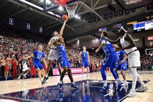 Creighton v Gonzaga - Oddstrader The cover for this college basketball picks today article shows forward Braden Huff #34 of the Gonzaga Bulldogs laying up a shot against guard Blake Harper #2 of the Creighton Bluejays.