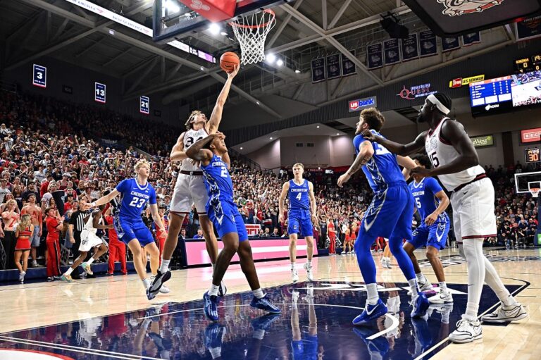 The cover for this college basketball picks today article shows forward Braden Huff #34 of the Gonzaga Bulldogs laying up a shot against guard Blake Harper #2 of the Creighton Bluejays.