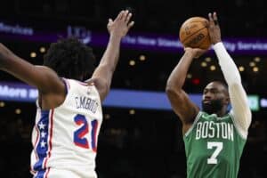 The cover for this NBA player props today article shows Jaylen Brown #7 of the Boston Celtics shooting the ball while guarded by Joel Embiid #21 of the Philadelphia 76ers