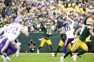 The cover for this NFL Thanksgiving Player Props article shows Jordan Love #10 of the Green Bay Packers throwing a pass against the Minnesota Vikings.