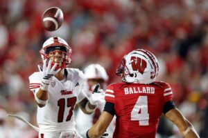 Miami (OH) v Wisconsin - Oddstrader The cover for this Wednesday night college football picks article shows Kaleb Martin #17 of the Miami (OH) Redhawks breaking up a pass intended for Jayden Ballard #4 of the Wisconsin Badgers