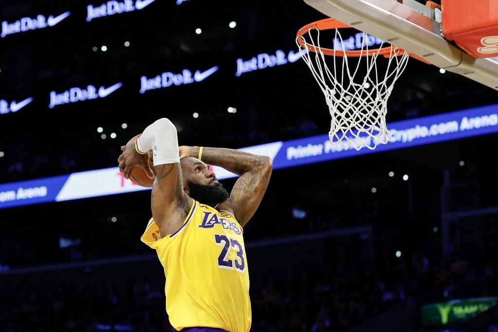 The cover for this NBA player props today article shows LeBron James #23 of the Los Angeles Lakers dunks the ball against the Minnesota Timberwolves.
