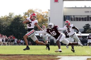 Georgia v Mississippi State - Oddstrader The cover for this Saturday college football article shows Noah Thomas #5 of the Georgia Bulldogs carrying the ball against Derion Gullette #16 of the Mississippi State Bulldogs.