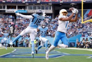 Los Angeles Chargers v Tennessee Titans - Oddstrader The cover for this Sunday night football picks articles shows Quentin Johnston #1 of the Los Angeles Chargers catching a pass for a touchdown against Jalyn Armour-Davis #18 of the Tennessee Titans