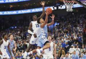 North Carolina v BYU - Oddstrader The cover for this college basketball picks today article shows Seth Trimble #7 of the North Carolina Tar Heels being pressured by Keba Keita #13 of the Brigham Young Cougars as he drives to the basket