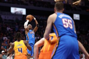 The cover for this NBA player props today article shows Shai Gilgeous-Alexander #2 of the Oklahoma City Thunder attempting a jump shot against the Charlotte Hornets.