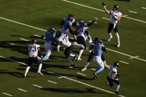 Jacksonville Jaguars v Tennessee Titans - NFL 2025 - Oddstrader The cover for this Sunday night football picks article shows Trevor Lawrence #16 of the Jacksonville Jaguars dropping back to pass against the Tennessee Titans.