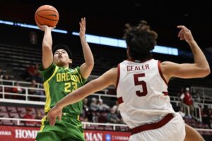 Oregon v Stanford - Oddstrader The cover for this college basketball picks today article shows Wei Lin #23 of the Oregon Ducks shooting against Benny Gealer #5 of the Stanford Cardinal