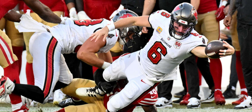 Baker Mayfield of The Tampa Bay Buccaneers - Oddstrader Baker Mayfield of The Tampa Bay Buccaneers reaching for a first down