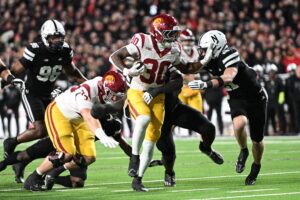 USC v Nebraska - Oddstrader King Miller of the USC Trojans, our top pick for Friday night college football, runs from Rex Guthrie of the Nebraska Cornhuskers.