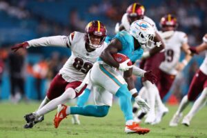 Washington Commanders v Miami Dolphins - Oddstrader Malik Washington #83 of the Miami Dolphins carries the ball against the Washington Commanders. The Dolphins and Commander will meet again for Sunday morning football.