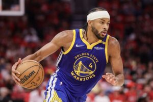 Golden State Warriors' Moses Moody, one of our top NBA player props today, drives to the basket against the Houston Rockets