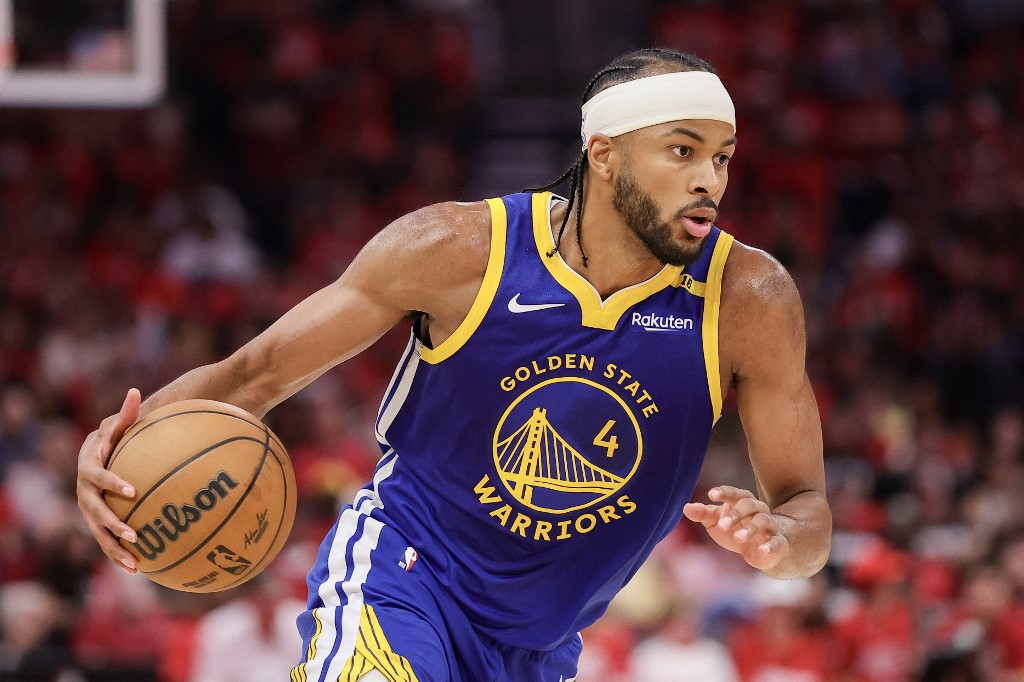 Golden State Warriors' Moses Moody, one of our top NBA player props today, drives to the basket against the Houston Rockets