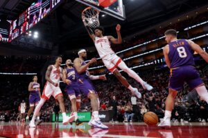 The cover for this NBA player props today article shows Amen Thompson #1 of the Houston Rockets dunks against Grayson Allen #8 and Jordan Goodwin #23 of the Phoenix Suns.