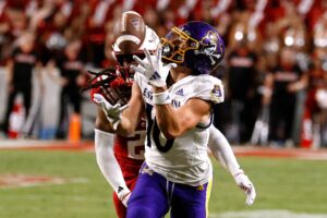 Brock Spalding #10 of the East Carolina Pirates makes a catch against Jamel Johnson #21 of the NC State Wolfpack