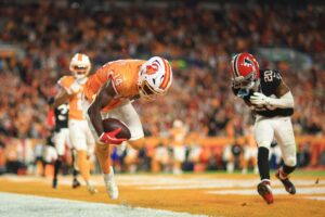 The cover for this early sunday football bets article shows Chris Godwin Jr. #14 of the Tampa Bay Buccaneers scores a two-point conversion against the Atlanta Falcons.