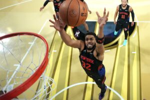The cover for this NBA player props today article shows Karl-Anthony Towns #32 of the New York Knicks grabs a rebound during the fourth quarter against the San Antonio Spurs.