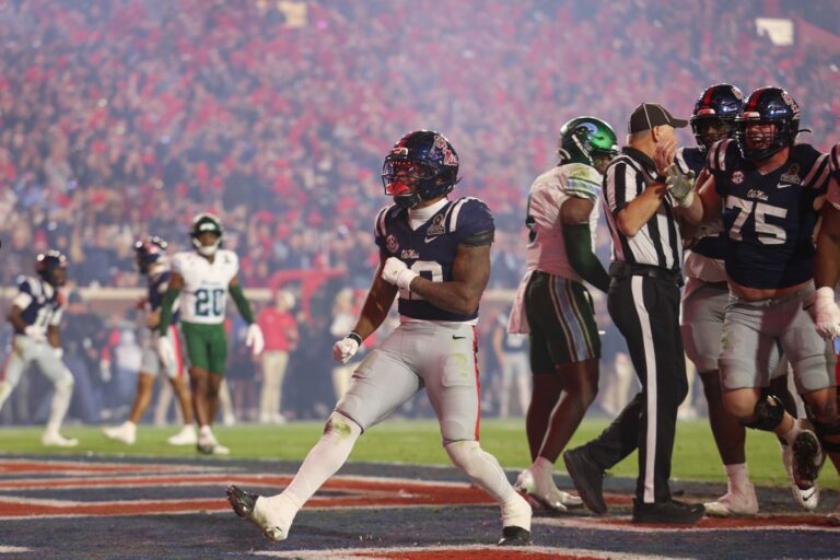 Logan Diggs #22 of the Ole Miss Rebels celebrates after scoring a touchdown during the fourth quarter of the 2025 College Football Playoff First Round Game against the Tulane Green Wave.