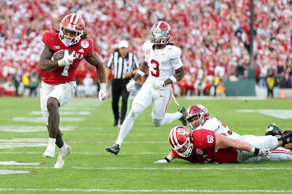 The cover for this College football odds bowls article shows Roman Hemby #1 of the Indiana Hoosiers running with the ball in the fourth quarter against the Alabama Crimson Tide.
