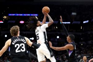 The cover for this NBA player props today article shows Stephon Castle #5 of the San Antonio Spurs in action during the game against Cody Williams #5 of the Utah Jazz.