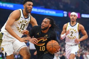 The cover for this NBA player props today article shows Tony Bradley #13 of the Indiana Pacers guarding Darius Garland #10 of the Cleveland Cavaliers.
