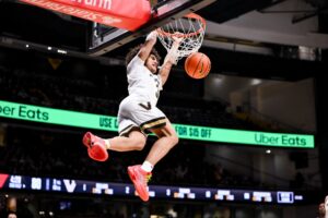 The cover for this college basketball picks today article shows Tyler Tanner #3 of the Vanderbilt Commodores dunking the ball against the SMU Mustangs.