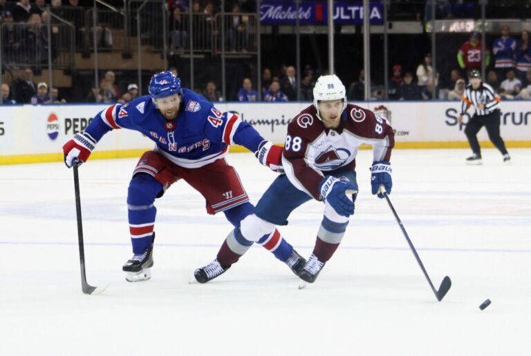 The cover for this NHL parlay picks today article shows Vladislav Gavrikov #44 of the New York Rangers defending against Martin Necas #88 of the Colorado Avalanche.