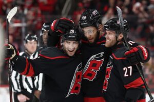 K'andre Miller #19 of the Carolina Hurricanes celebrates with his team following a goal during the second period of the game against the Dallas Stars.