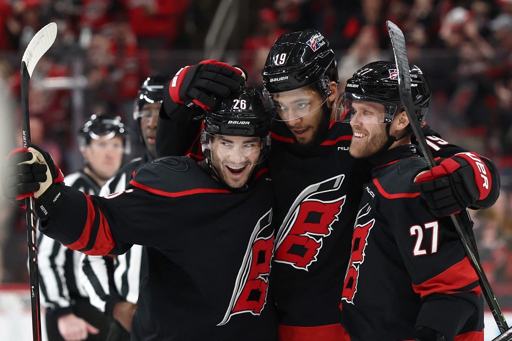 K'andre Miller #19 of the Carolina Hurricanes celebrates with his team following a goal during the second period of the game against the Dallas Stars.