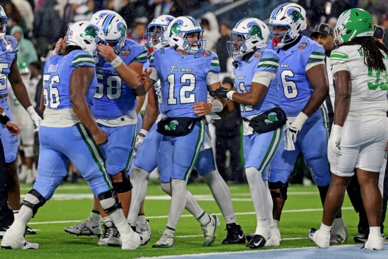 Jake Retzlaff #12 of the Tulane Green Wave celebrates after scoring on a 1-yard run on fourth down as time expired in the first half against the North Texas Mean Green.