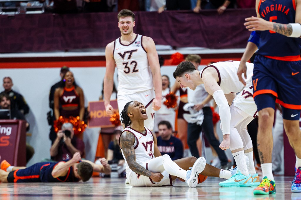 The cover for this college basketball picks today article shows Ben Hammond #3 reacting with Neoklis Avdalas #17 of the Virginia Tech Hokies in overtime against the Virginia Cavaliers.