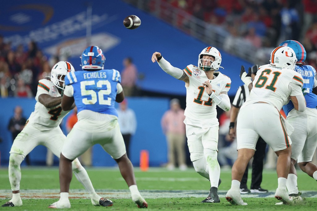 The cover for this College football national championship player props article shows Carson Beck #11 of the Miami Hurricanes throwing a pass during the Vrbo Fiesta Bowl.