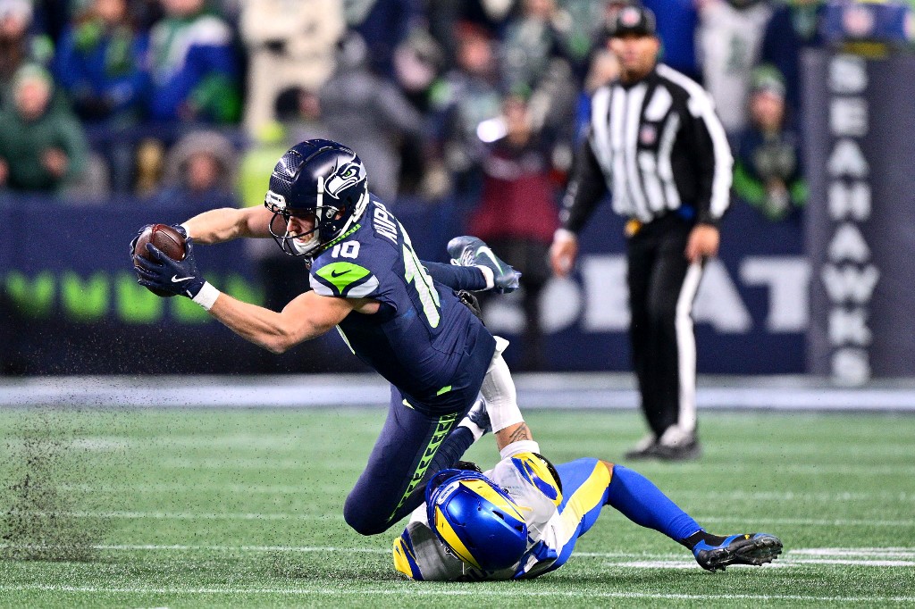 The cover for this NFL Super Bowl Player Props article shows Cooper Kupp #10 of the Seattle Seahawks catching a pass during the fourth quarter against the Los Angeles Rams in the NFC Championship game.