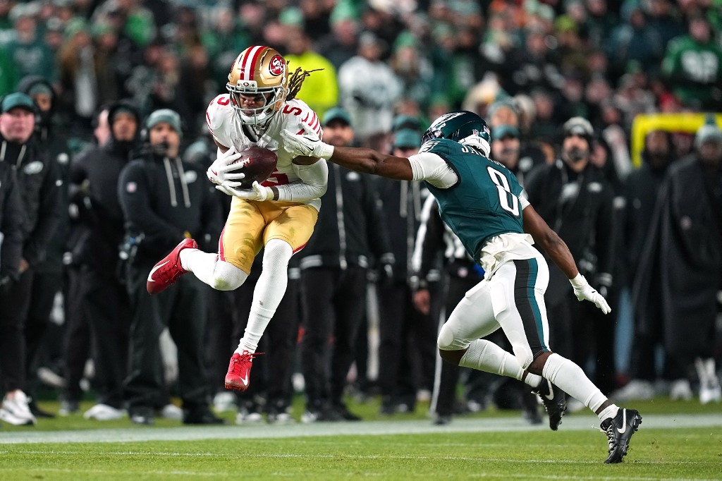 The cover for this NFL picks divisional round article shows Demarcus Robinson #5 of the San Francisco 49ers catching a pass against Adoree' Jackson #8 of the Philadelphia Eagles.