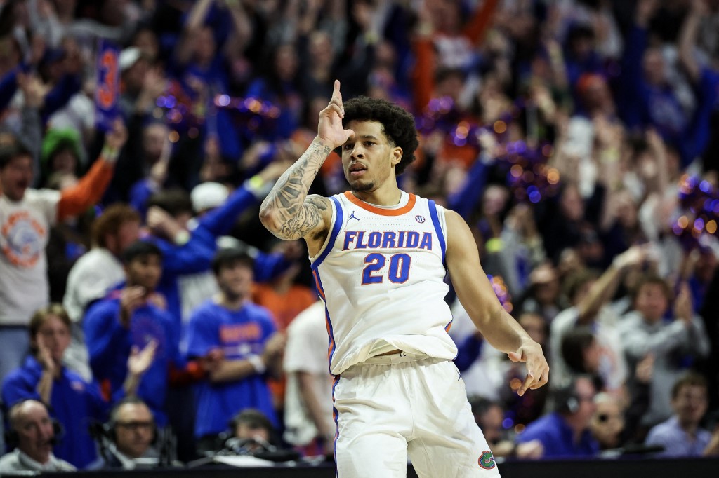 The cover for this college basketball picks today article shows Isaiah Brown #20 of the Florida Gators celebrating after making a three point basket during the first half of a game against the LSU Tigers.