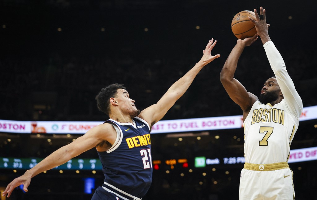 The cover for this NBA player props today article shows Jaylen Brown #7 of the Boston Celtics shoots over Spencer Jones #21 of the Denver Nuggets.