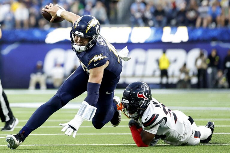 Houston Texans v Los Angeles Chargers - NFL 2025 - Oddstrader - Oddstrader The cover for this NFL Wild Card Player props article shows K'Von Wallace #38 of the Houston Texans tripping up Justin Herbert #10 of the Los Angeles Chargers.