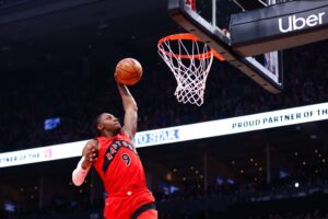 The cover for this NBA player props today article shows RJ Barrett #9 of the Toronto Raptors dunking against the Golden State Warriors.