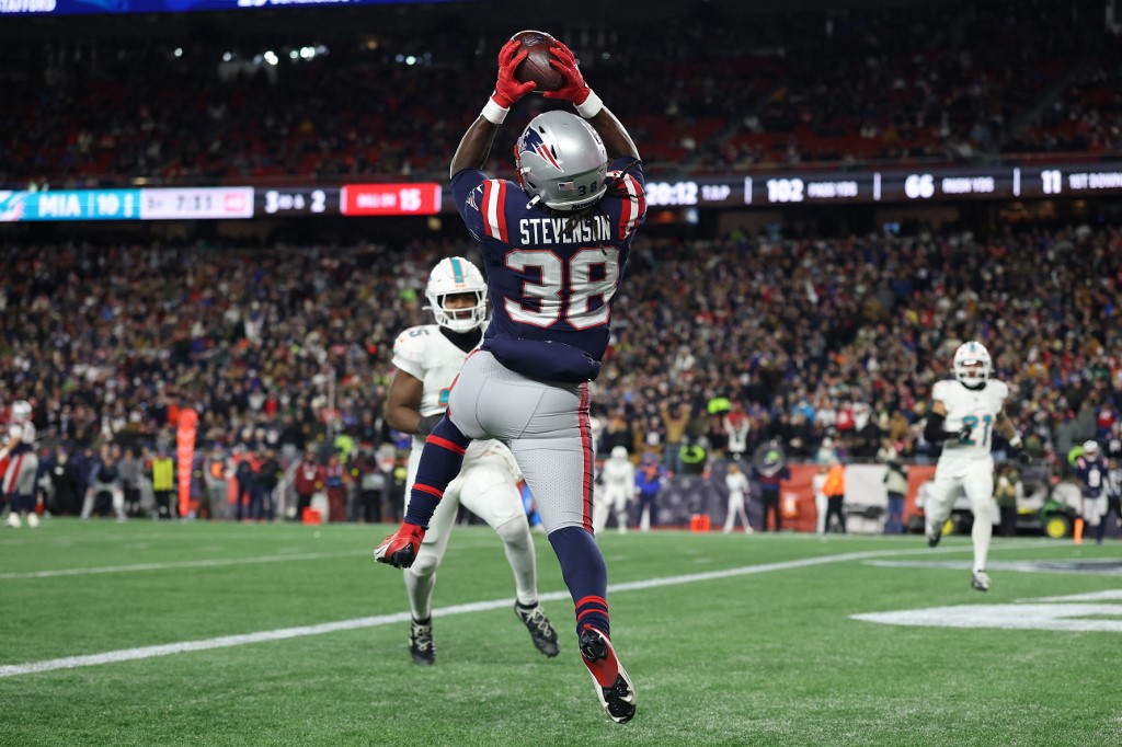 Rhamondre Stevenson #38 of the New England Patriots catches a pass for a touchdown in the third quarter against the Miami Dolphins