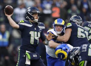 NFC Championship Game Los Angeles Rams v Seattle Seahawks - Oddstrader The cover for this NFL super bowl picks article shows Sam Darnold #14 of the Seattle Seahawks throwing a pass during the first quarter against the Los Angeles Rams in the NFC Championship game.