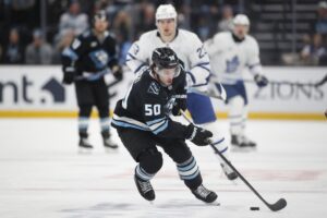 The cover for this NHL picks today article shows Sean Durzi #50 of the Utah Mammoth turning the puck up the ice against the Toronto Maple Leafs.