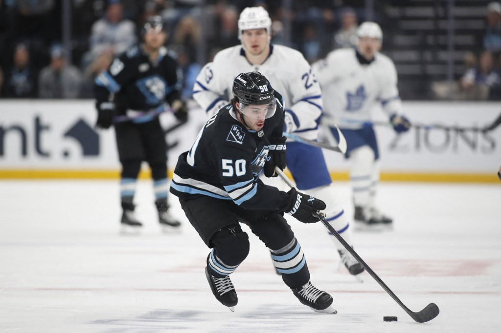 The cover for this NHL picks today article shows Sean Durzi #50 of the Utah Mammoth turning the puck up the ice against the Toronto Maple Leafs.
