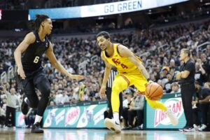 Chad Baker-Mazara #4 of the USC Trojans handles the ball against Jordan Scott #6 of the Michigan State Spartans.