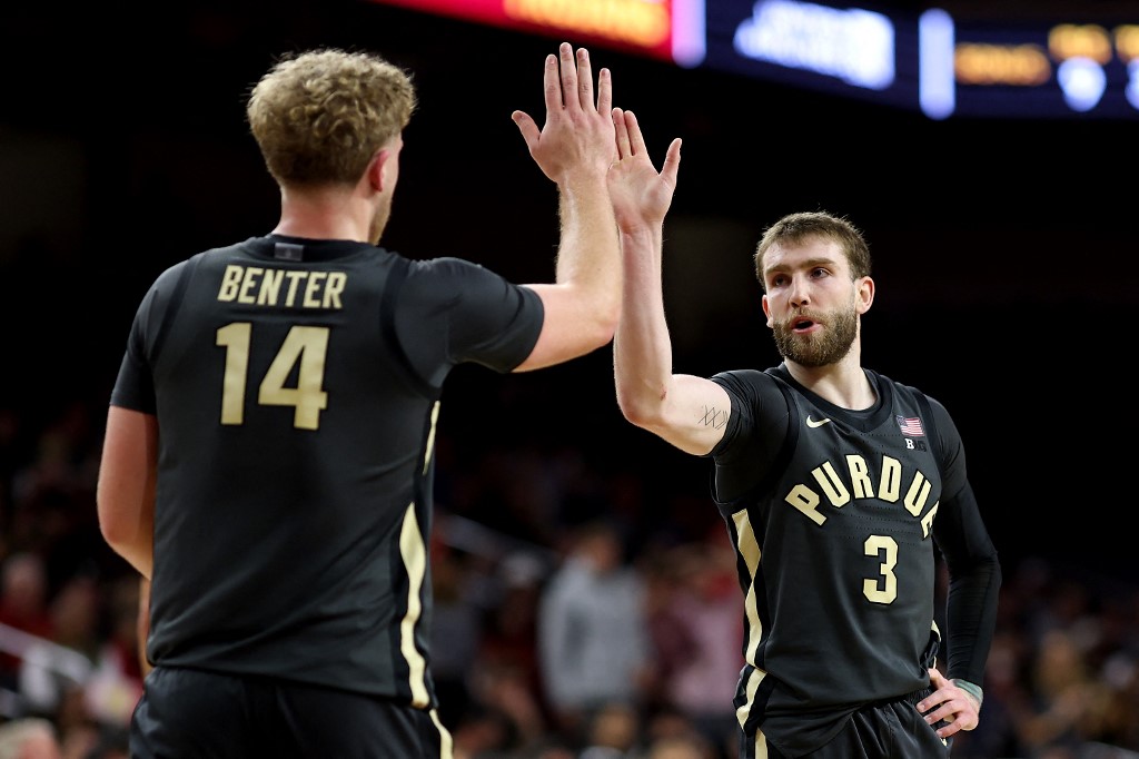 Jack Benter #14 high fives Braden Smith #3 of the Purdue Boilermakers against the USC Trojans.